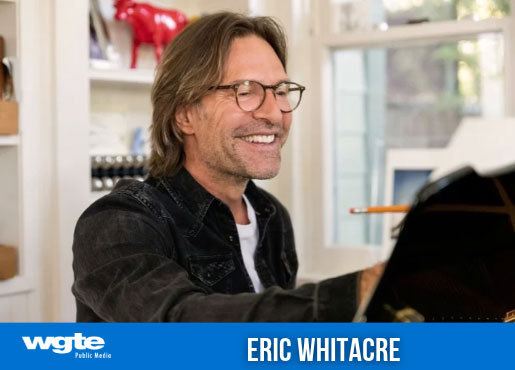 Eric Whitacre smiles at the piano