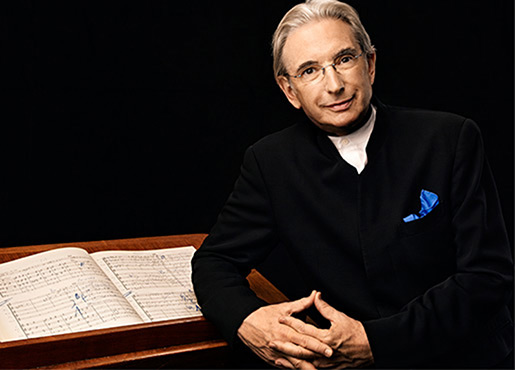 man standing next to a conductor podium 