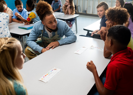 teacher sitting with students 