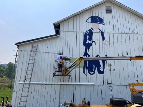  Scott Hagan paints Commodore Abraham Whipple on a barn near Marietta, Ohio. Historians say the shipbuilder lived in the area.