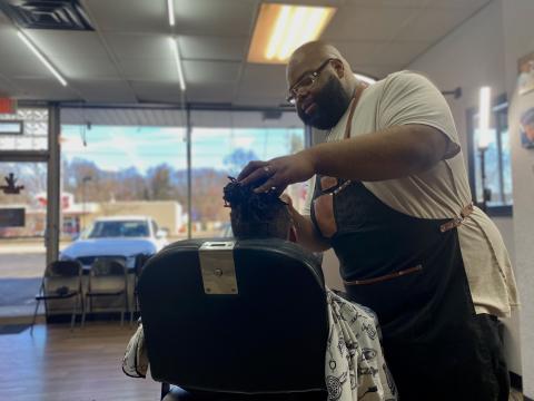  Al Favors, known as Big A, cuts a young clients hair. He's recently brought mental health resources into his barbershop.