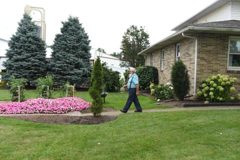 Atlee Kaufman walks from his home to his business next door, Bentwood Solutions.