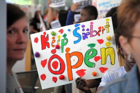  Siebert Elementary School students carry signs during a May community engagement meeting at a library near their school. Siebert Elementary is among 20 school buildings Columbus City Schools is considering closing in a consolidation plan.