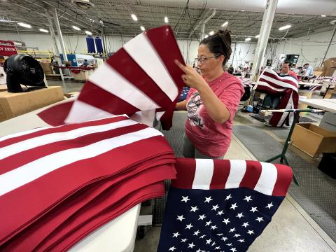  A worker in Annin Flagmakers' Coshocton factory sews together the stars and stripes of American flag. The factory produces more than 3 million full-size American flags each year.