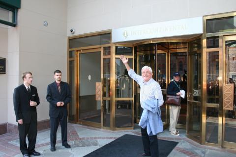 Phil Donahue waves to fans as he leaves his hotel during the Toronto Film Festival. 