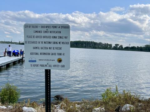 A sign at a beach in Toledo warns people about the risk of harmful bacteria in Lake Erie.