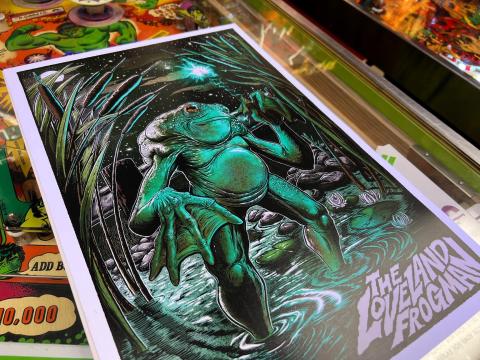 A poster of the Loveland Frogman in Brian Maxson's barbershop shows the creature standing in a river. Maxson will host a Frogger competition Saturday in celebration of the cryptid.
