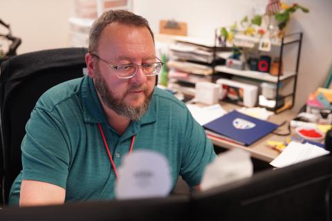 Bryon Bell, deputy director of the Wayne County Board of Elections, reviews applications for absentee ballots from members of the military and citizens abroad at the agency's headquarters in Wooster, Ohio, on Friday, Oct. 25, 2024.