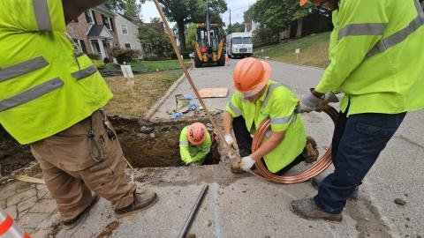 A crew from Greater Cincinnati Water Works rolls out new copper pipe to replace a brass service line at a home in September; like lead, brass lines must be replaced with copper according to new rules from the EPA.