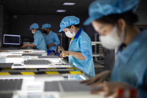 Rows of factory workers solder together solar cells at Red Sun Energy’s factory outside Ho Chi Minh City, Vietnam. The solar company is one of dozens manufacturing in Vietnam, Cambodia, Malaysia and Thailand impacted by tariffs imposed by the US this year.