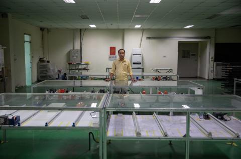 Nguyen Quoc Chinh, factory director of Red Sun Energy’s plant outside Ho Chi Minh City, stands in an empty production room that is no longer in use due to reduced sales.
<br>
<br>
