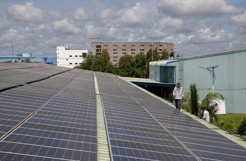 Workers repair gutters on the roof of Red Sun Energy’s manufacturing factory outside Ho Chi Minh City, Vietnam. The company is one of dozens in Southeast Asia hit with new tariffs on solar imports to the U.S.
