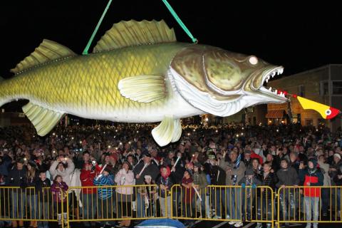 A large fiberglass fish hangs above a crowd of people in Port Clinton. Each year, Port Clinton drops Wylie the Walleye on New Year's Eve.