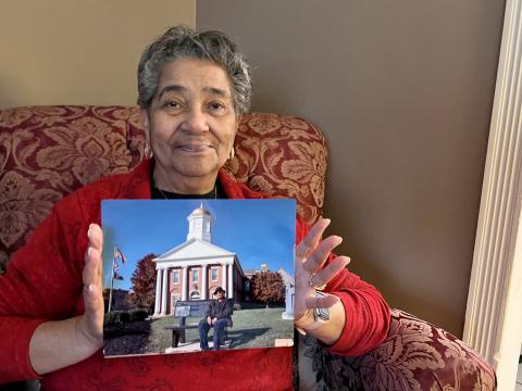 Virginia Harewood and her mother Elsie Steward Young marched together for equal education in 1954. Harewood holds a photo of her mother on a bench outside of Hillsboro's courthouse.