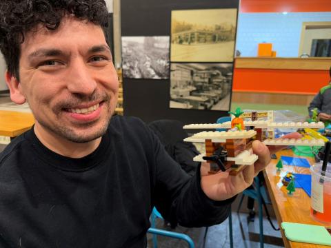 Alan Cruz builds a Wright Brothers biplane out of random Lego parts during a meet up at the CoHatch in downtown Springfield, Ohio.