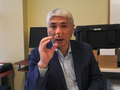 Kai Zhao, a professor of nasal physiology at Ohio State University's department of otolaryngology, wears a pair of nasal plugs. Zhao tested the plugs, made of foam earplugs with a straw embedded, to see if they could help people with smell dysfunction better perceive and identify odors.