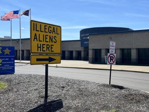 Sheriff Richard Jones has placed a neon yellow sign that reads "Illegal Aliens Here" in front of his jail, off and on, for two decades.