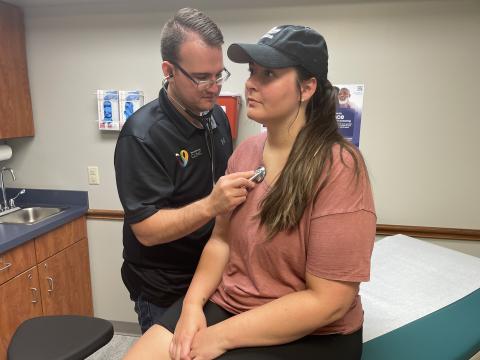 Mark Yoder (left) listens to a patient's lungs during her appointment at the Viola Startzman Clinic in Wooster on June 4, 2025.