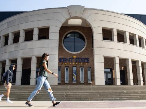 People walk past the Memorial Athletic and Convocation Center at Kent State University's main campus. The university recently announced the closure of some of its identity-based support services.