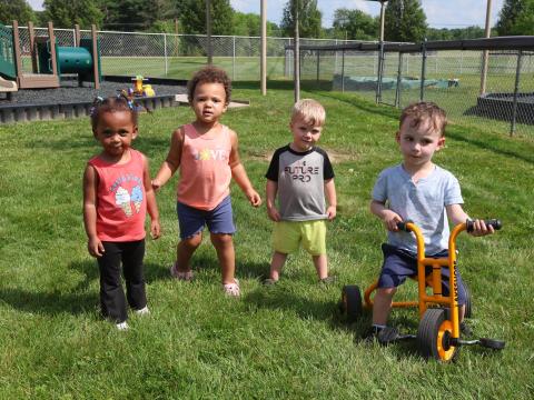 A group of children pose for a photo at Knox County Head Start, a child care center in north central Ohio. Some families in the region say child care is their biggest bill.