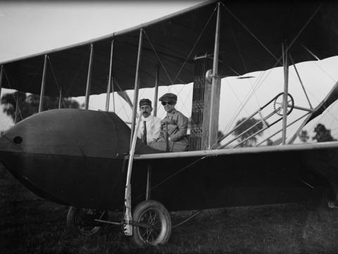 Katharine and Orville Wright sit aboard a Wright Model HS airplane.