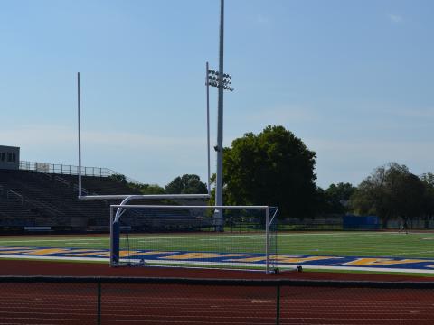 A goal post sits at the end of a football field.