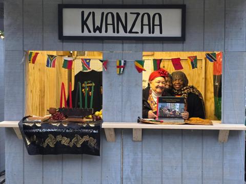 Diane Gordon holds the book she wrote about Kwanzaa at Toledo's celebration of the African American holiday last year.
