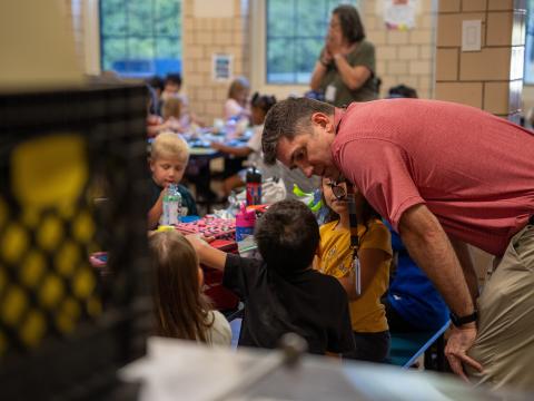 Spanish Immersion School Principal Michael Brennan talks to students during lunch at the K-8 school in Mansfield.