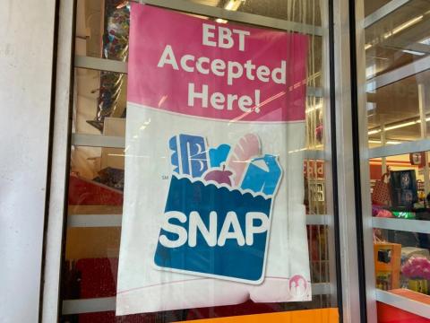 A sign shows electronic benefit transfer (EBT) cards used for SNAP benefits is accepted at a store in Columbus.