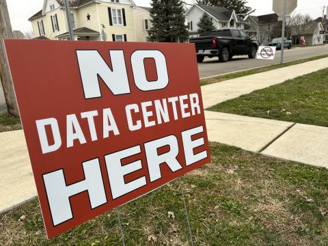 Signs opposing a data center north of Ashville, Ohio line the streets of that village.
