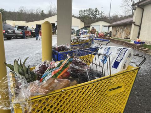 Volunteers line up carts at Brookside Church's weekly food pantry on a chilly morning in March.