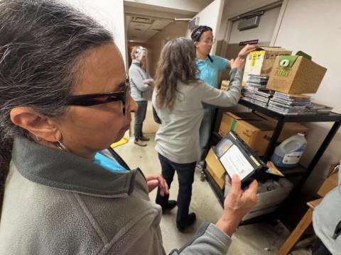 Radio preservationist Jocelyn Robinson inspects audio artifacts with the HBCU Radio Preservation Project team at Central State University in May 2025.