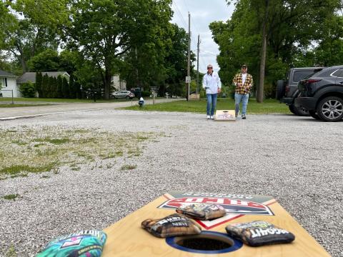 Frank Geers and Fin Walter play cornhole outside of the American Cornhole Organization headquarters in Camp Dennison on the east side of Cincinnati.