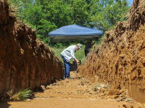 Brad Lepper, senior World Heritage archaeologist with the Ohio History Connection, cleans the side of a trench in a field in Granville, where subsurface imaging showed the possible remnants of an earthwork circle on May 28, 2026.