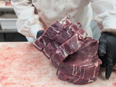 Chase Meeks organizes cuts of beef for a customer's order. He manages the only butcher shop in southeast Ohio's Athens and Meigs counties.