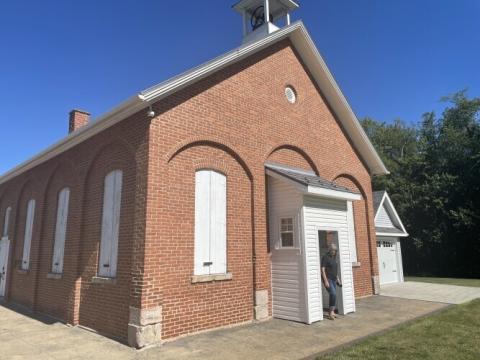 Pike Township Administrator Molly Wadsworth walks outside of the Melscheimer one-room schoolhouse on the southern edge of Stark County on June 24, 2026. The call to abolish property taxes has her and other township leaders across Ohio concerned.