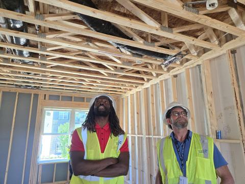 Cincinnati code inspectors Obadare Ajao and Gino Battistella look over construction progress at a townhouse development. Both graduated from the Cincinnati Code Inspector Training Academy last year.