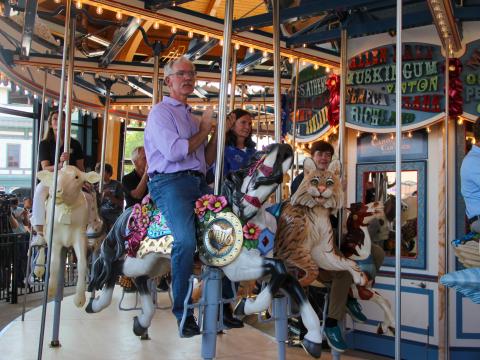 Todd Goings, president of Carousels and Carvings in Marion, sits on a horse during the inaugural ride of the new carousel at the Ohio State Fairgrounds.