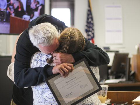 Michael Kincaid hugs Licking County Municipal Court H.O.M.E. Court Program Coordinator and Community Navigator Sherry Selfe after graduating from the court diversion program on Wednesday, Aug. 12, 2026.