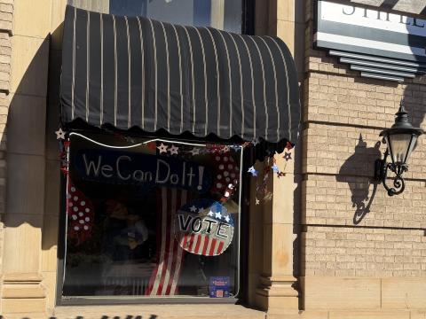 A storefront window in Wooster features a mannequin dressed up as Rosie the Riveter with the slogan on the window, "We can do it!" on Oct. 3, 2026, a reminder to patrons at Woosterfest, of the upcoming November elections.